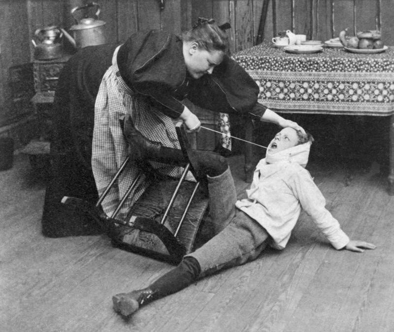 Victorian Mother pulling out her son's tooth